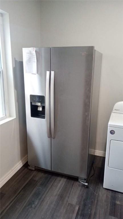interior space with washer / clothes dryer, laundry area, dark wood-style floors, and baseboards