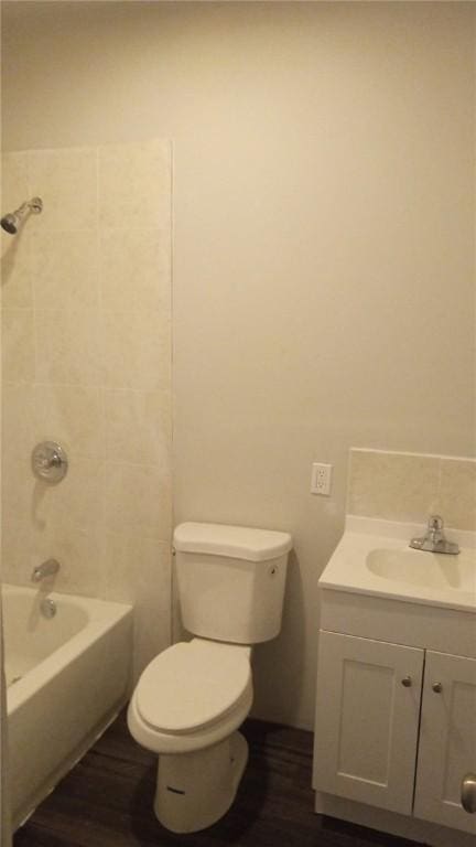 bathroom with vanity, shower / bathing tub combination, toilet, and wood finished floors