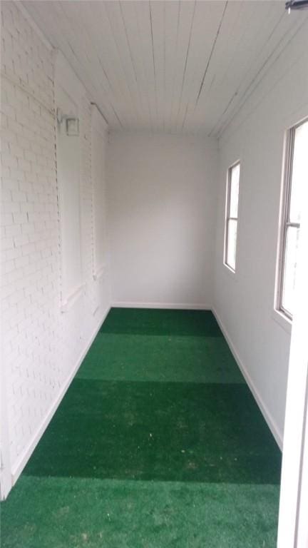 carpeted empty room with baseboards