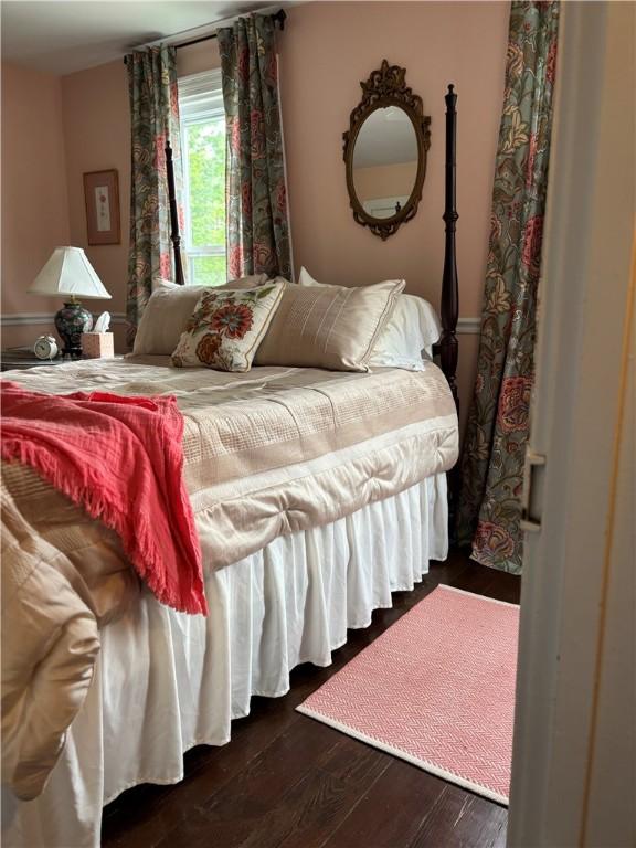 bedroom with dark wood finished floors