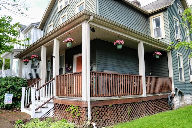 view of side of home with covered porch