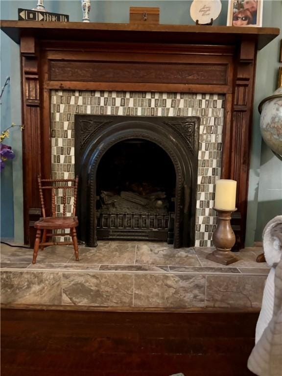room details featuring wood finished floors and a tile fireplace
