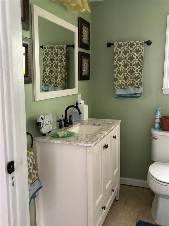 full bath featuring toilet, tile patterned floors, baseboards, and vanity