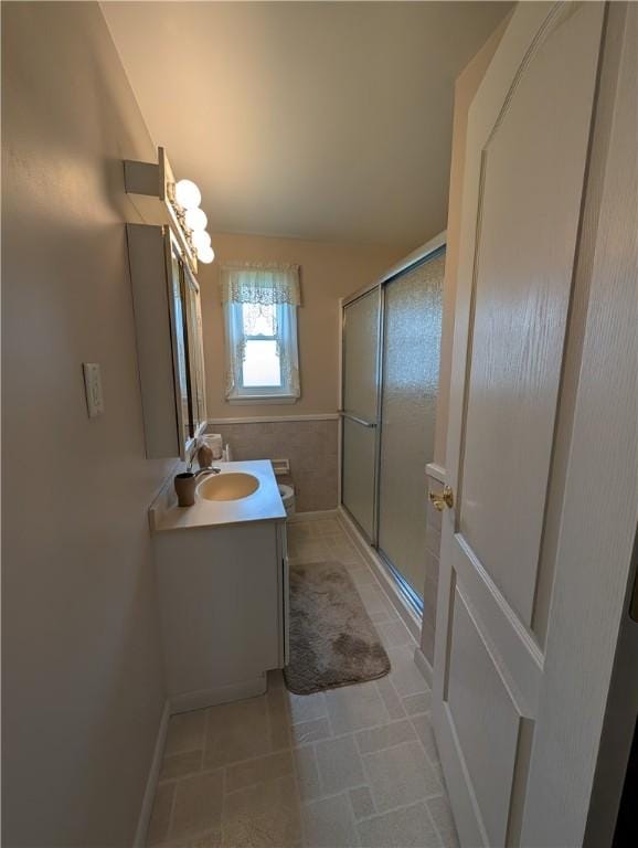 bathroom with vanity, tile patterned flooring, and a shower stall