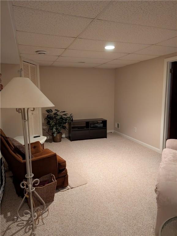 interior space featuring visible vents, carpet flooring, baseboards, and a drop ceiling