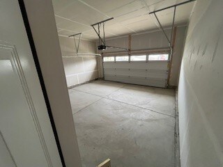 345 Stately Ct, Adams Twp, PA 16046 - garage featuring a garage door opener