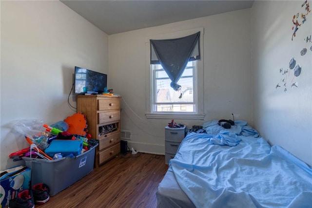 bedroom with visible vents and wood finished floors