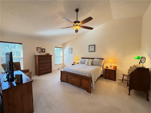 bedroom featuring light colored carpet, a textured ceiling, a ceiling fan, baseboards, and vaulted ceiling