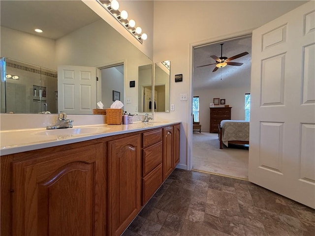 ensuite bathroom featuring double vanity, a sink, a ceiling fan, and ensuite bath