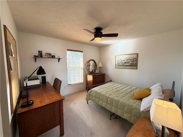 bedroom with a ceiling fan, a textured ceiling, and carpet