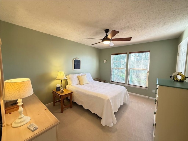 carpeted bedroom with baseboards, a textured ceiling, and ceiling fan