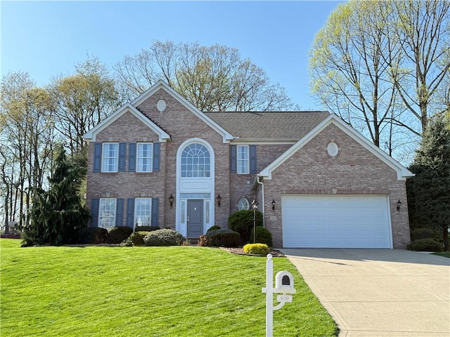 view of front of home with a garage, driveway, a front lawn, and brick siding