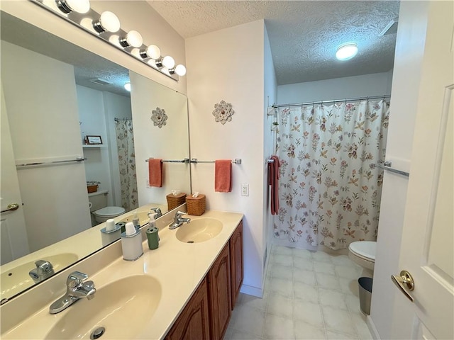 full bathroom featuring a sink, a textured ceiling, and toilet