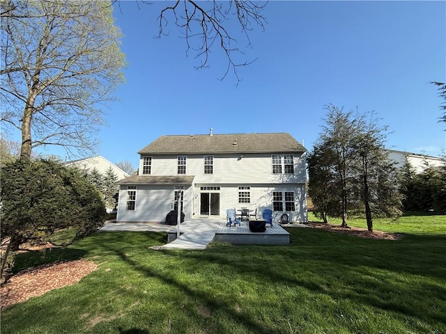 rear view of house with a lawn and a patio area