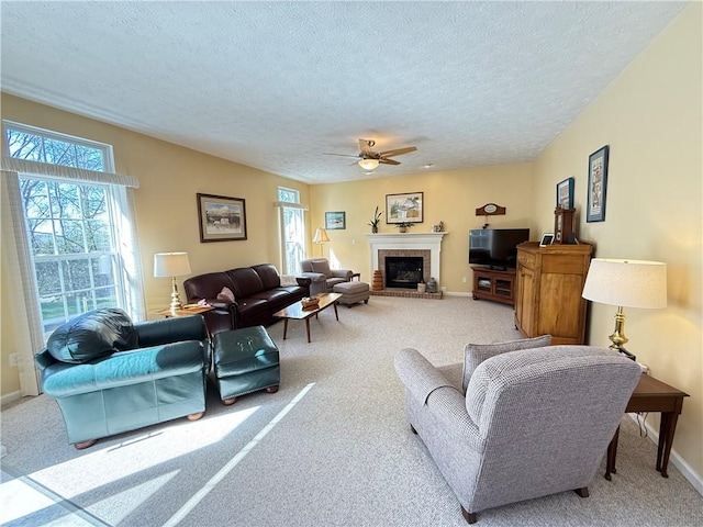 living room with carpet floors, a ceiling fan, and a healthy amount of sunlight