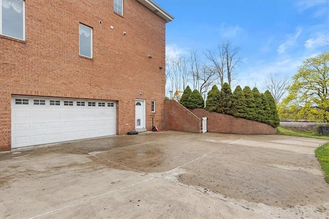 5076 Brownsville Rd, Whitehall, PA 15236 - view of home's exterior with a garage, concrete driveway, and brick siding