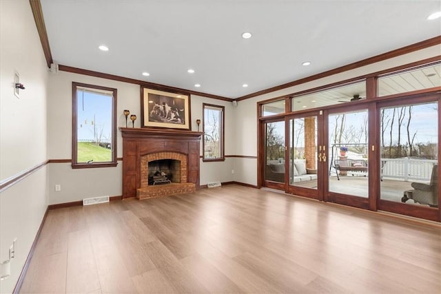 5076 Brownsville Rd, Whitehall, PA 15236 - unfurnished living room featuring crown molding, a brick fireplace, baseboards, light wood-type flooring, and visible vents
