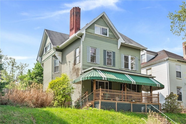 704 E 10th Ave, Munhall, PA 15120 - back of house with covered porch and a chimney