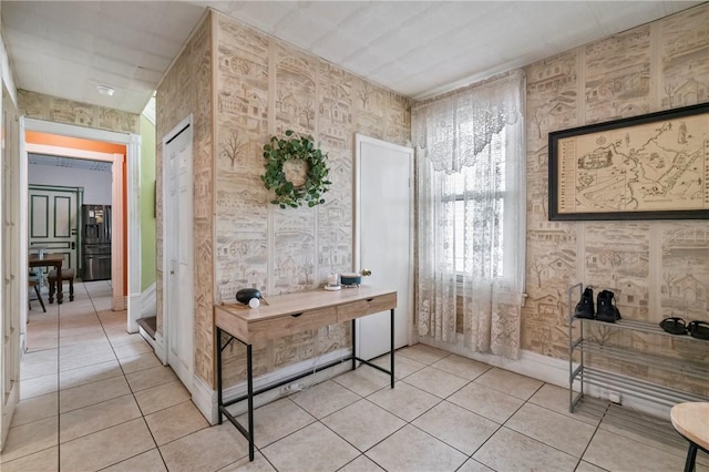 704 E 10th Ave, Munhall, PA 15120 - corridor with light tile patterned flooring, wallpapered walls, and baseboards