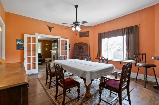 704 E 10th Ave, Munhall, PA 15120 - dining area featuring french doors, a ceiling fan, and dark wood-style floors