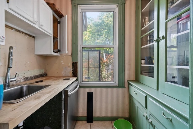 704 E 10th Ave, Munhall, PA 15120 - kitchen featuring wooden counters, dishwasher, a sink, light tile patterned floors, and green cabinets