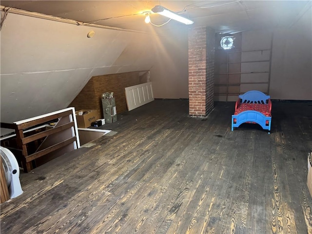additional living space with vaulted ceiling and hardwood / wood-style floors