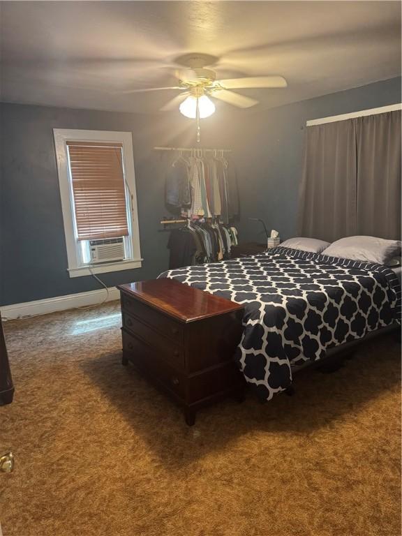 bedroom with ceiling fan, carpet, and cooling unit