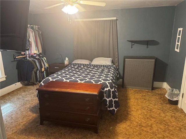 carpeted bedroom featuring ceiling fan and baseboards