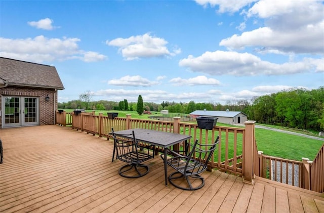 deck with a yard and outdoor dining space
