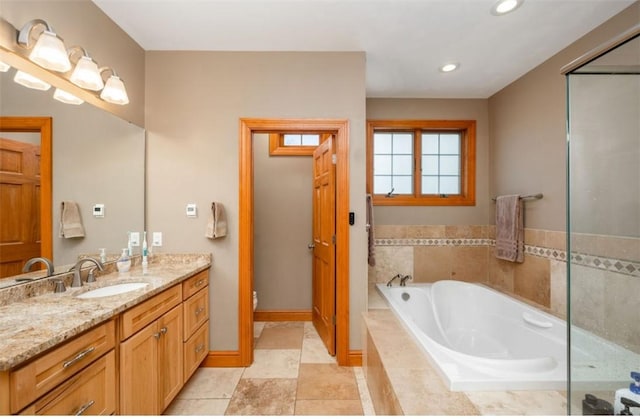 bathroom featuring toilet, recessed lighting, a garden tub, and vanity