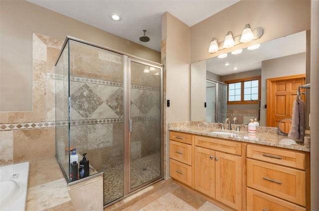 bathroom with vanity, tile patterned floors, a bath, and a stall shower