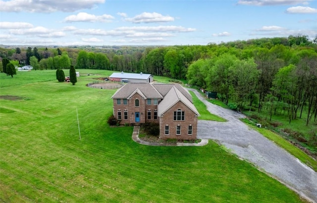 drone / aerial view featuring a wooded view