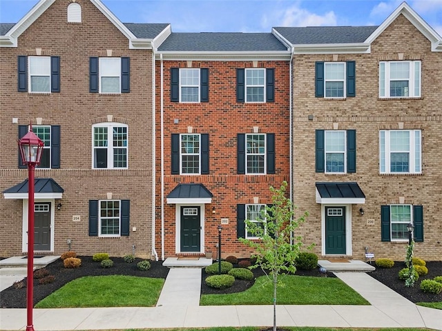 townhome / multi-family property with brick siding