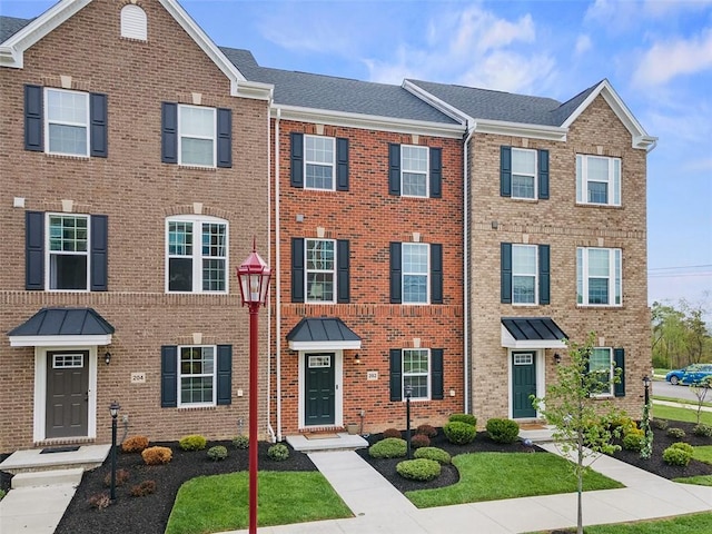 townhome / multi-family property featuring brick siding