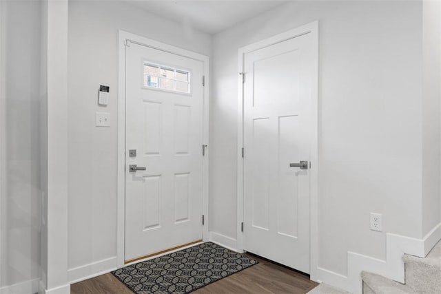 entryway with baseboards, stairs, and wood finished floors