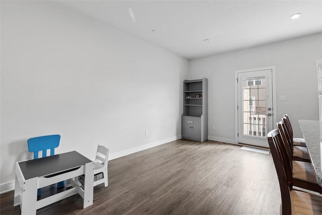unfurnished office with baseboards and wood finished floors