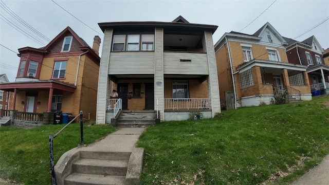 view of front of property with covered porch and a front yard