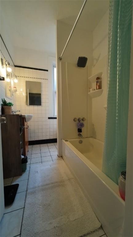 bathroom featuring tile walls, tile patterned flooring, vanity, and shower / bathtub combination with curtain