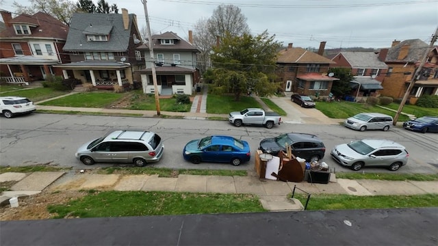 exterior space with curbs, sidewalks, and a residential view