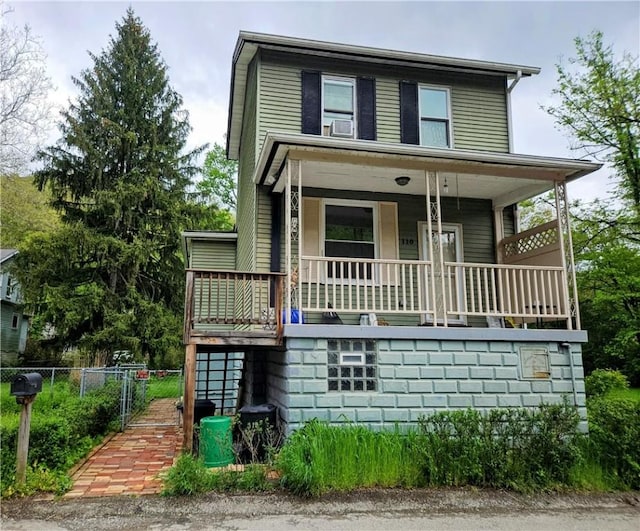 view of front of property with a porch and fence