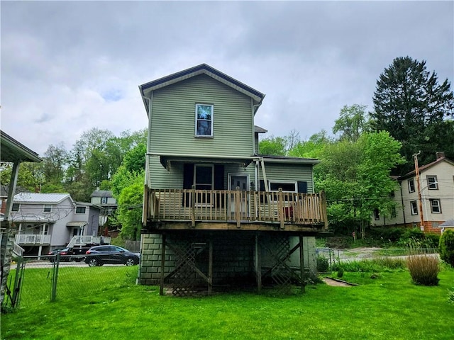 rear view of property with a yard, fence, and a wooden deck