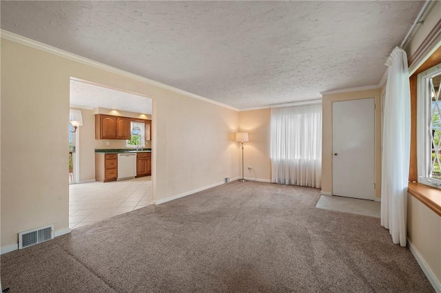 unfurnished room featuring visible vents, a textured ceiling, light tile patterned floors, and light carpet