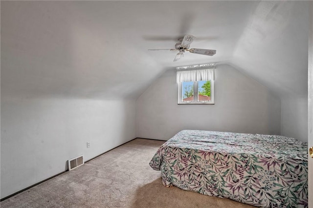bedroom with carpet floors, ceiling fan, vaulted ceiling, and visible vents