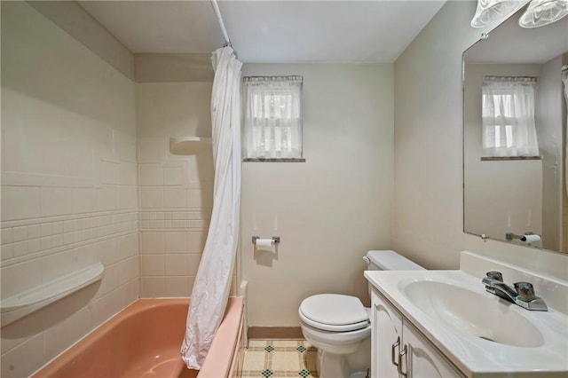 full bathroom with toilet, baseboards, a healthy amount of sunlight, and vanity