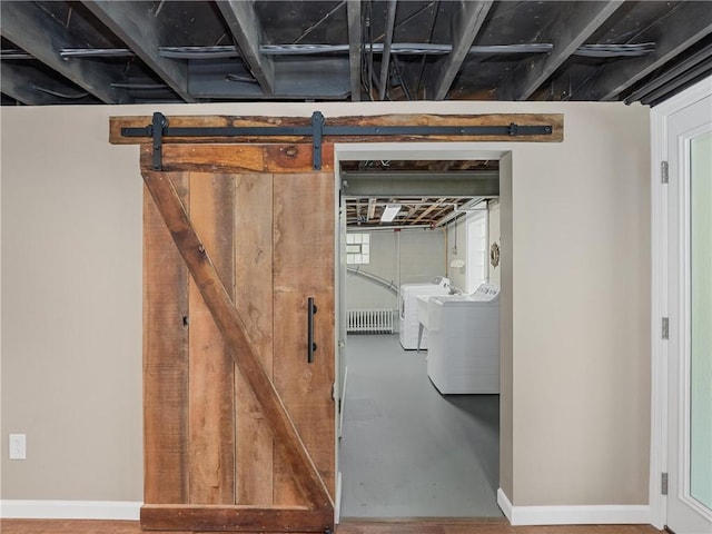 basement featuring baseboards and separate washer and dryer