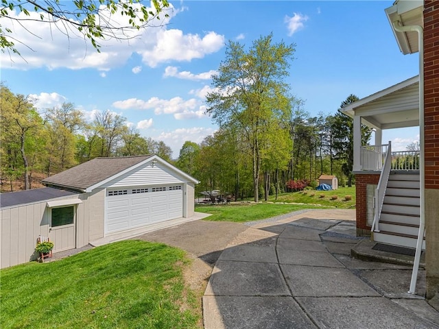exterior space featuring stairway, an outbuilding, and a garage