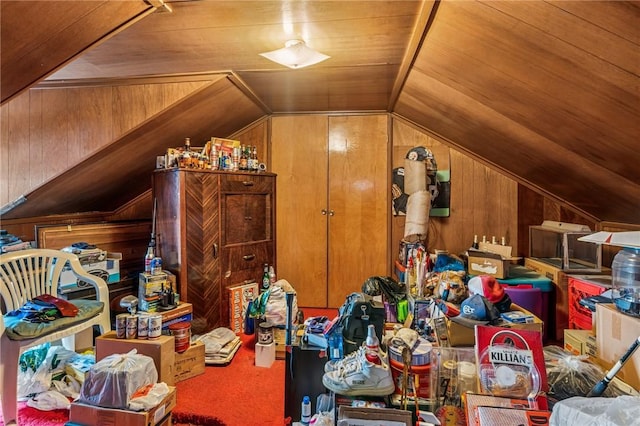 additional living space featuring lofted ceiling, carpet, and wooden walls