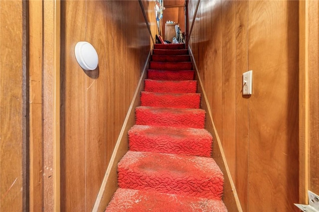 stairway with wood walls