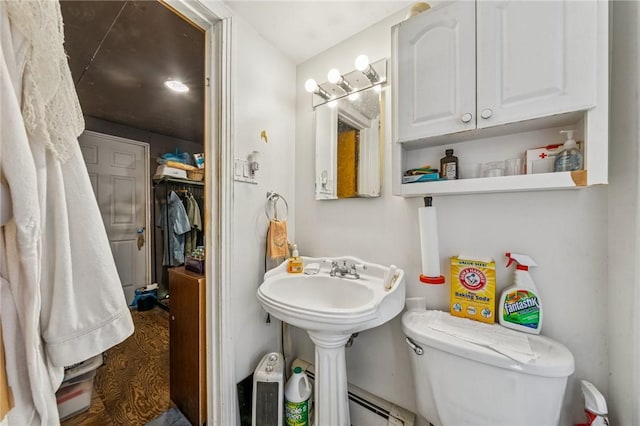 bathroom featuring toilet and baseboard heating