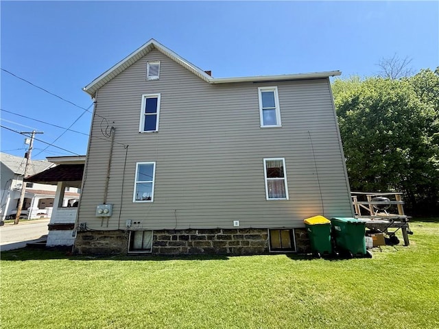 rear view of property featuring a yard